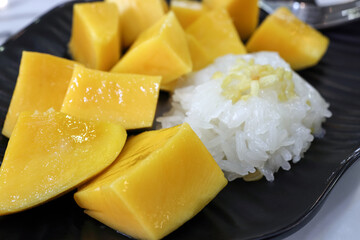 Thai style mango with sticky rice with sprinkle of crunchy friend yellow lentil dal