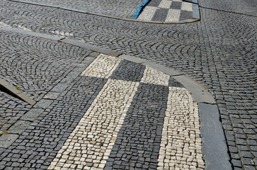 mosaic of small marble cubes. sidewalks and squares formed by stone carpet with squares, polka dots...