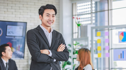 Portrait shot Asian happy cheerful smart confident millennial professional successful male businessman entrepreneur in casual blazer suit standing crossed arms smiling in company office meeting room