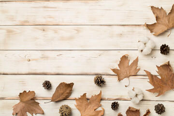 Flat lay composition with autumn leaves on wooden background, top view