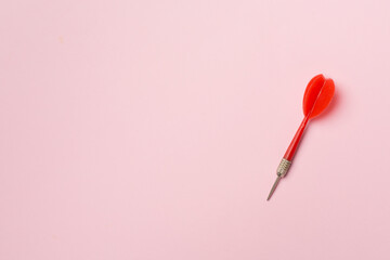 Red darts on color background, top view