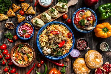 Uzbek and Central Asia cuisine concept. Assorted Uzbek food pilaf samsa lagman manti shurpa Uzbek...