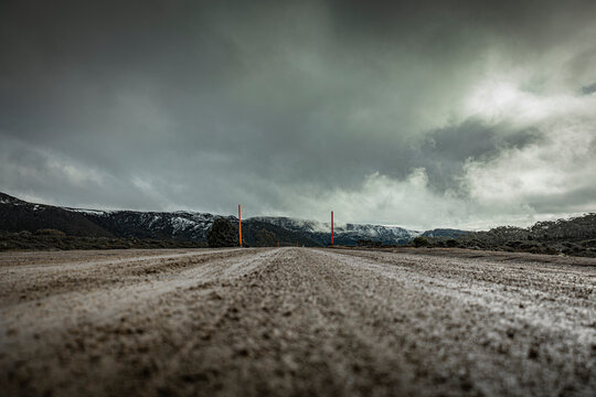 Dirt road with a storm in the mountains