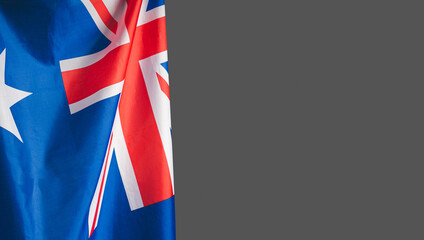 Close-up of the Australian flag is on the left side on a gray background