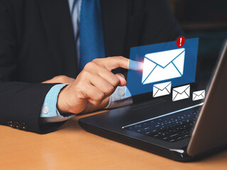 Businessman receives a new message with email icons on a virtual screen