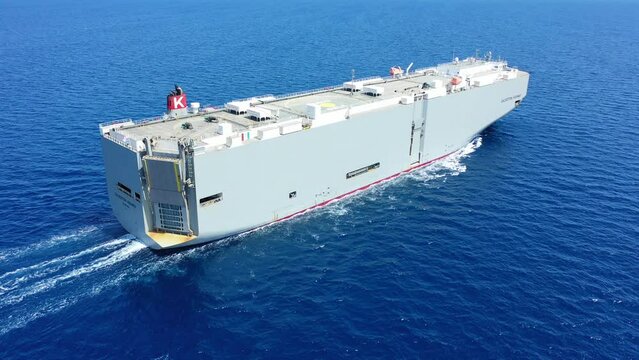 Aerial drone video of huge car carrier ship RO-RO (Roll on Roll off) cruising near Mediterranean destination port
