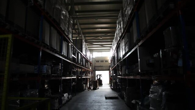 Industrial warehouse. Warehouse of a trade organization. Goods and materials arranged on a rack in warehouse. Warehouse store stock. 