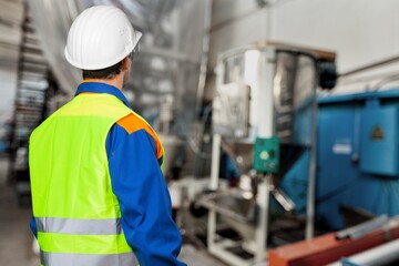 Young men worker in safety uniform, hard hat,  on industrial manufacturer factory