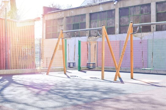 Empty colorful playground with swings for children sunny day. High quality photo