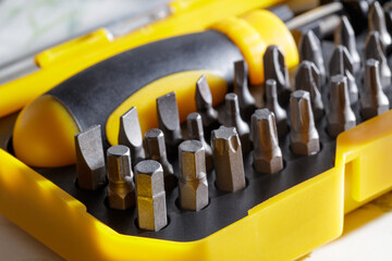 Fototapeta premium portable yellow screwdriver with bits. construction tool