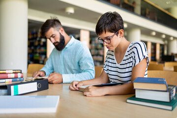 Education friendship people concept. Group of happy students learning together in college library