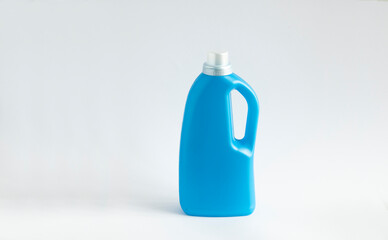 Blue plastic bottle stands on white background. Conditioner or liquid powder for washing. Capacity...