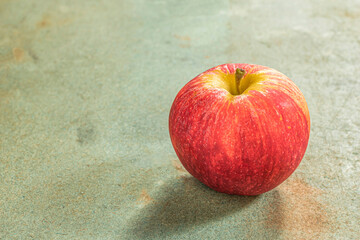 Healthy fruit apple on green wood table close up.