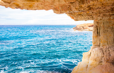 Beautiful picturesque cliffs of Ayia Napa in Cyprus. Arch Bridge of lovers. On the Mediterranean coast, background with a beautiful rock texture as a concept for travel and tourist excursions.