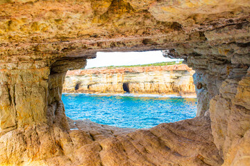 Beautiful picturesque cliffs of Ayia Napa in Cyprus. Arch Bridge of lovers. On the Mediterranean coast, background with a beautiful rock texture as a concept for travel and tourist excursions.