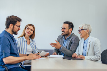 Business colleagues having a meeting together, talking to each other.