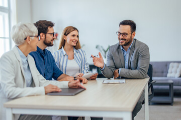 Four people having a meeting, talking to each other about the work.