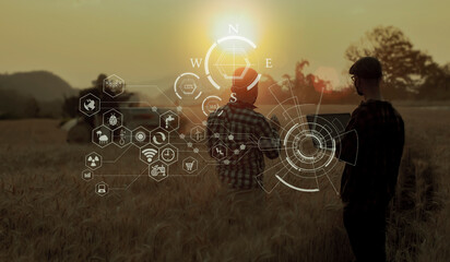 Farmer using digital laptop computer and modern interface icons with light shines sunset, Business agriculture technology concept.