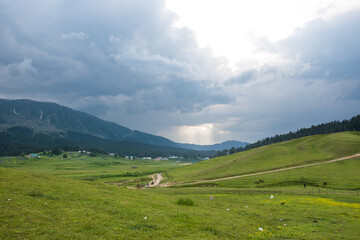 Stunning photograph of Kashmir valley (Paradise on Earth). Beautiful view of Gulmarg Valley surrounded by snow frozen Himalayas glacier mountains and green fir, Gulmarg, Jammu Kashmir India
