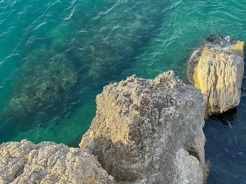 Sea and rocks. Coastal rocks and turquoise sea water. Beautiful seascape.