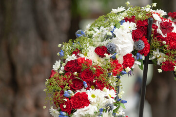 Closeup of a red and white sympathy wreath..