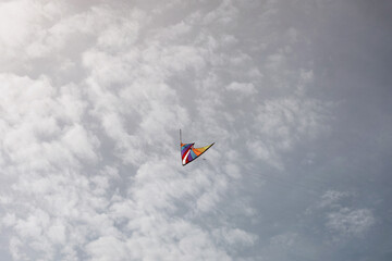 Naklejka na ściany i meble colorful kite flying with waving in sky
