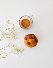 cup of coffee and vanila muffin on white background