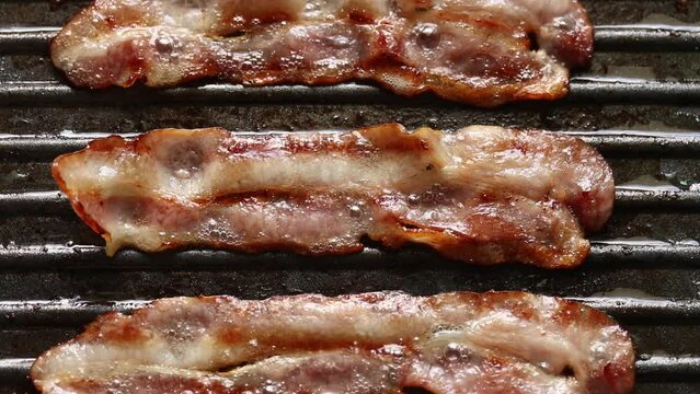 Top view of frying bacon on fry pan