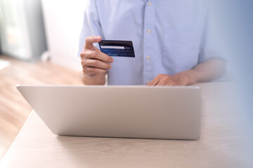 shopper using laptop online shopping. And using credit card online payment option or digital wallet online transaction.