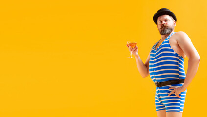 Funny seaman, fat cheerful man wearing retro striped swimsuit posing isolated on bright yellow background. Vacation, summer, humor