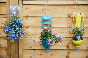 Sustainable Plant Holders Made From Repurposed Recycled Plastic Bottles In Garden
