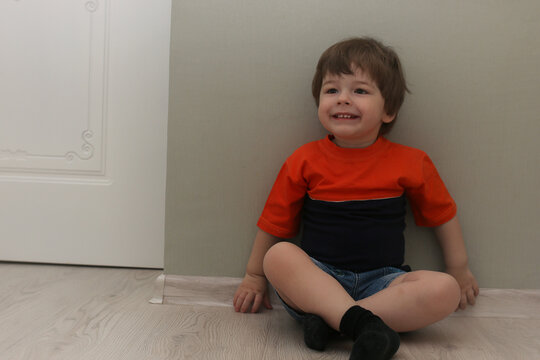 Young kid playing on a floor in a room