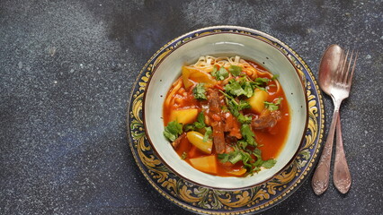 Traditional asian noodle soup with vegetables, potatoes and meat, - lagman. Oriental, uzbek style cuisine