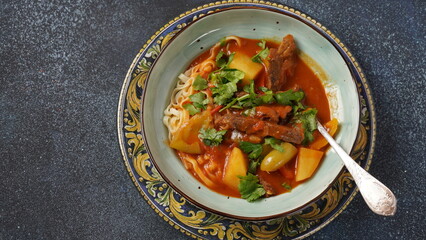 Traditional asian noodle soup with vegetables, potatoes and meat, - lagman. Oriental, uzbek style cuisine