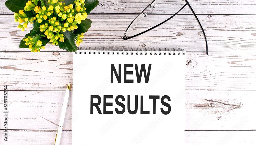 Poster new results text concept write on notebook on wooden background