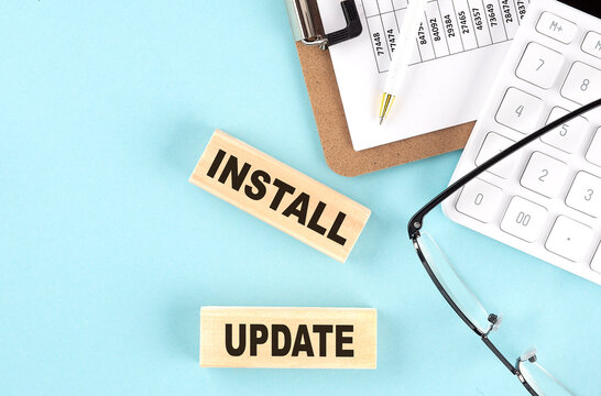 INSTALL UPDATE text written on wooden block with clipboard,eye glasses and calculator Business concept. - Powered by Adobe