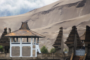 View of "Luhur Poten" hindu temple at Mount Bromo with cloudy sky background in Bromo Tengger Semeru National Park. 