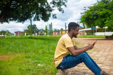 African American man using mobile phone in the park