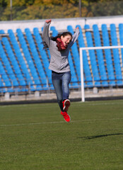 Teenage girl runs on the stadium