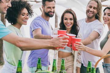 Photo of positive cool people enjoy celebrate holiday hanging out drink alcohol outdoors
