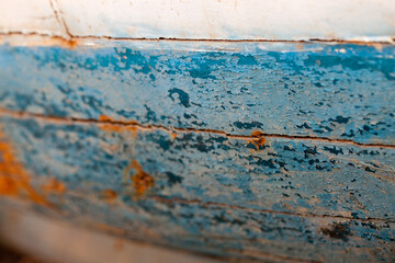 detail of old and worn boat hull painted with oil paint