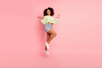 Full body photo of young pretty woman have fun energetic jump up isolated over pink color background