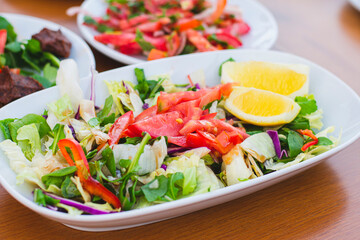 summer salad made with tomato lettuce and various vegetables