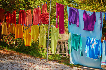 Colorful clothes hanging on the rope repeating rainbow colors