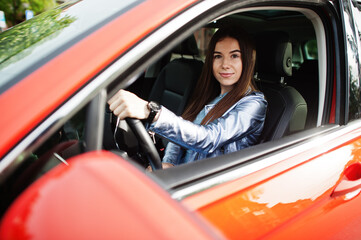 Gorgeous woman sitting inside car interior.