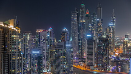 View of various skyscrapers in tallest recidential block in Dubai Marina aerial night timelapse