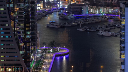Aerial view on yachts floating in harbor night timelapse.