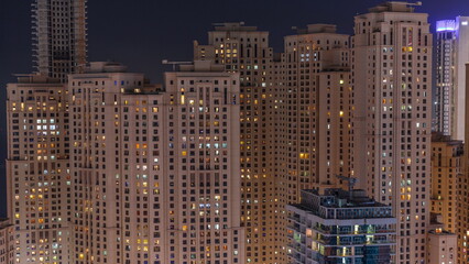Jumeirah Beach Residence and original architecture yellow towers in Dubai aerial night timelapse.