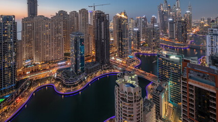 Obraz premium View of various skyscrapers in tallest recidential block in Dubai Marina aerial day to night timelapse