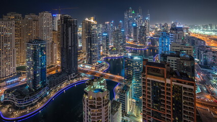 Fototapeta na wymiar Panorama showing various skyscrapers in tallest recidential block in Dubai Marina aerial night timelapse